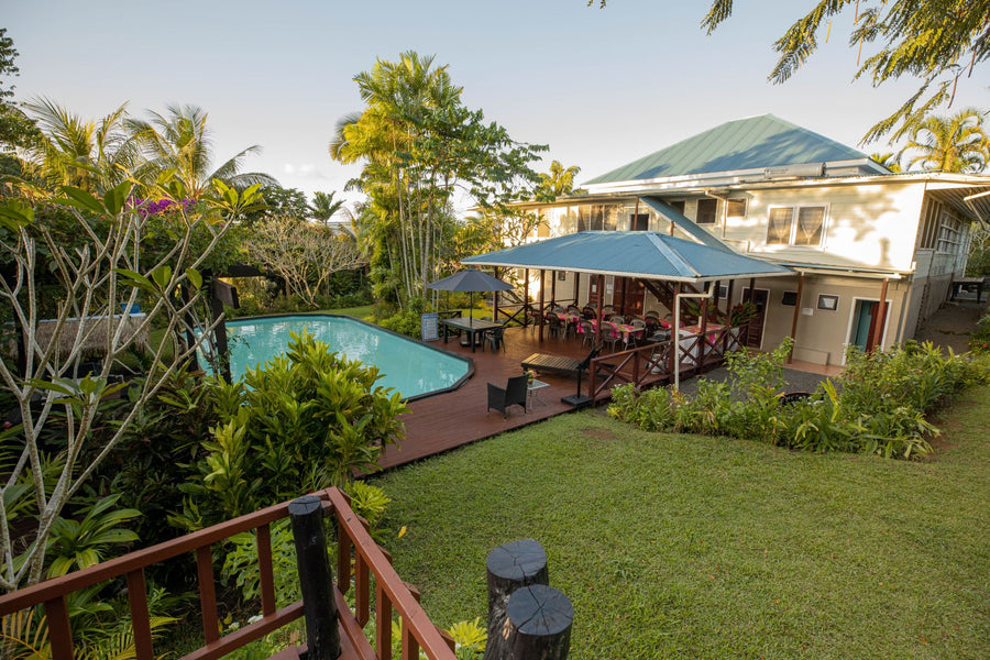 View from garden fale deck to the swimming pool and open shared dining area